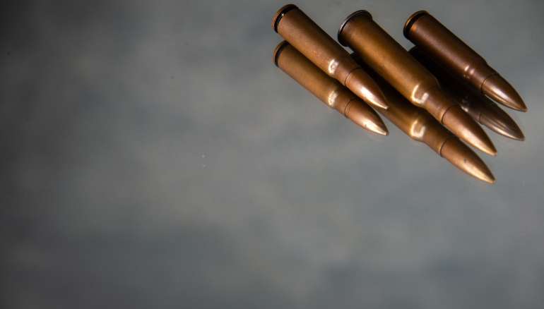 brown bullets on a gray background gun tank death war shooting