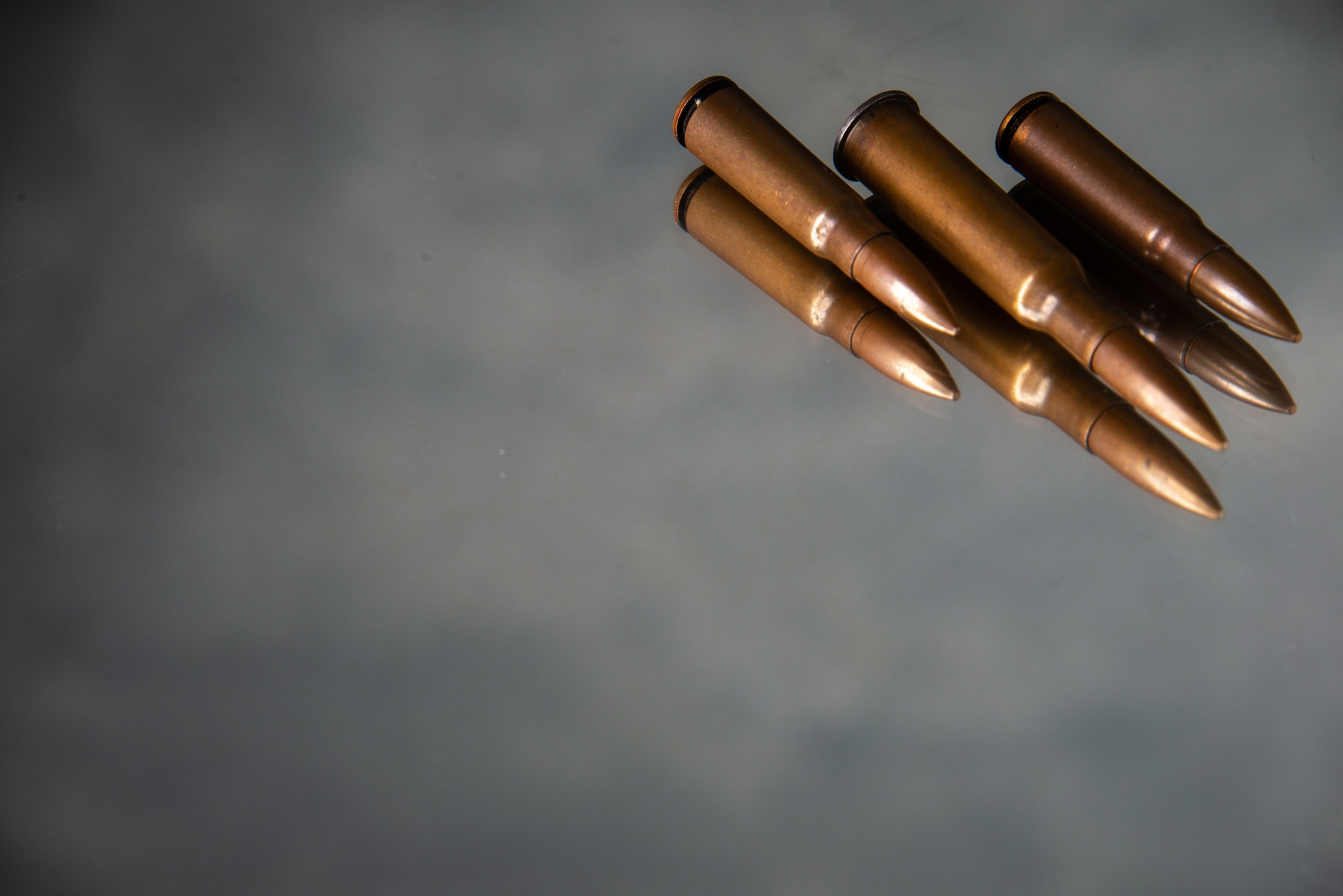 brown bullets on a gray background gun tank death war shooting