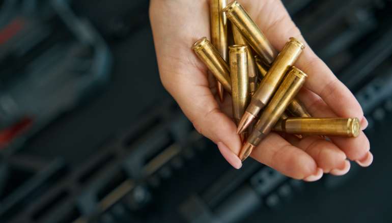 Combat cartridges on a tender female palm